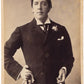 Alfred Ellis, phot. Oscar Wilde holding gloves and a cigarette.