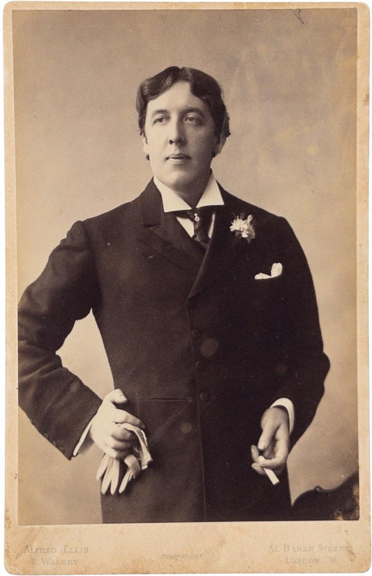 Alfred Ellis, phot. Oscar Wilde holding gloves and a cigarette.